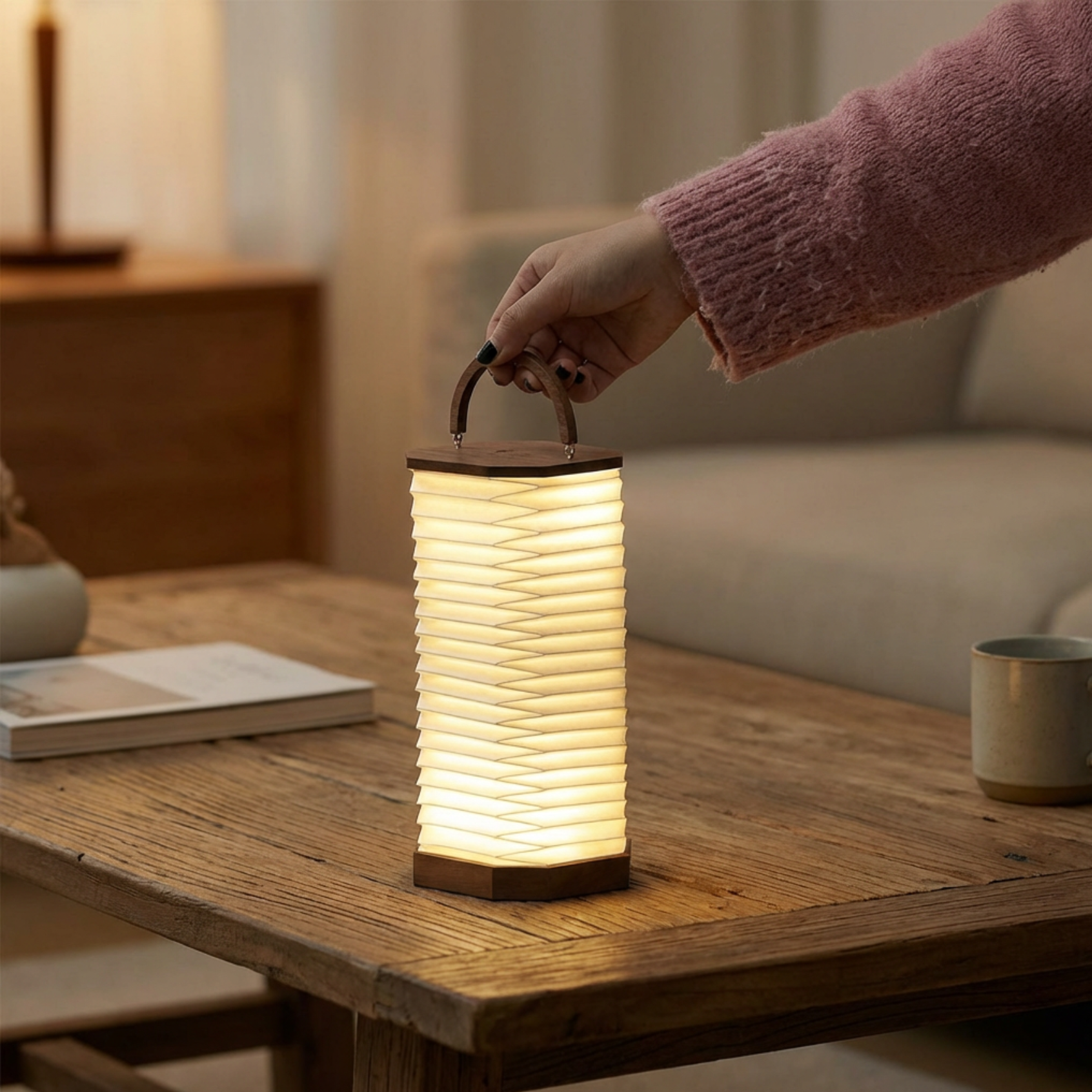 Armonica Table Lamp with a soft glow, featuring a textured design and a handle for easy portability.