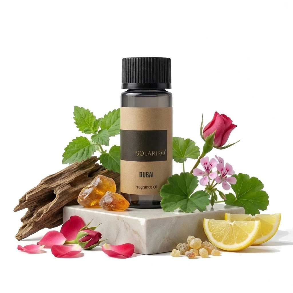 Fragrance Oil - Dubai in a dark bottle surrounded by flowers, wood, and citrus elements.