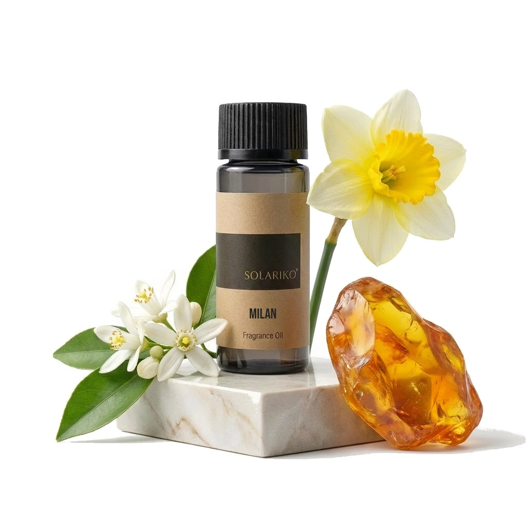 Fragrance Oil - Milan in a bottle with flowers and amber resin on a marble surface.